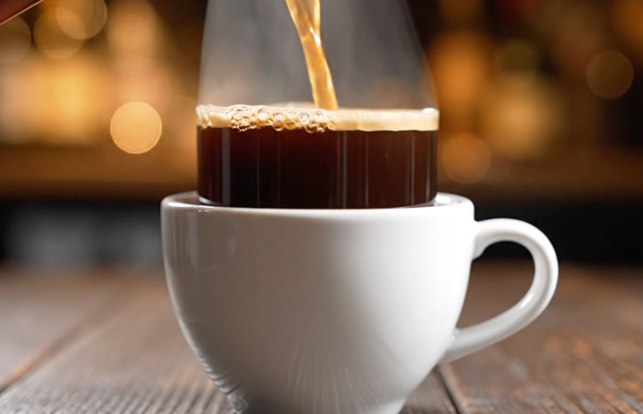 Coffee cup representing routine, energy, and the need for systems over mood